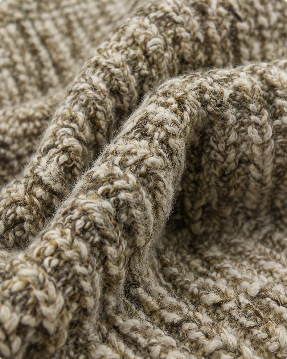Close-up of a chunky, textured knitted fabric